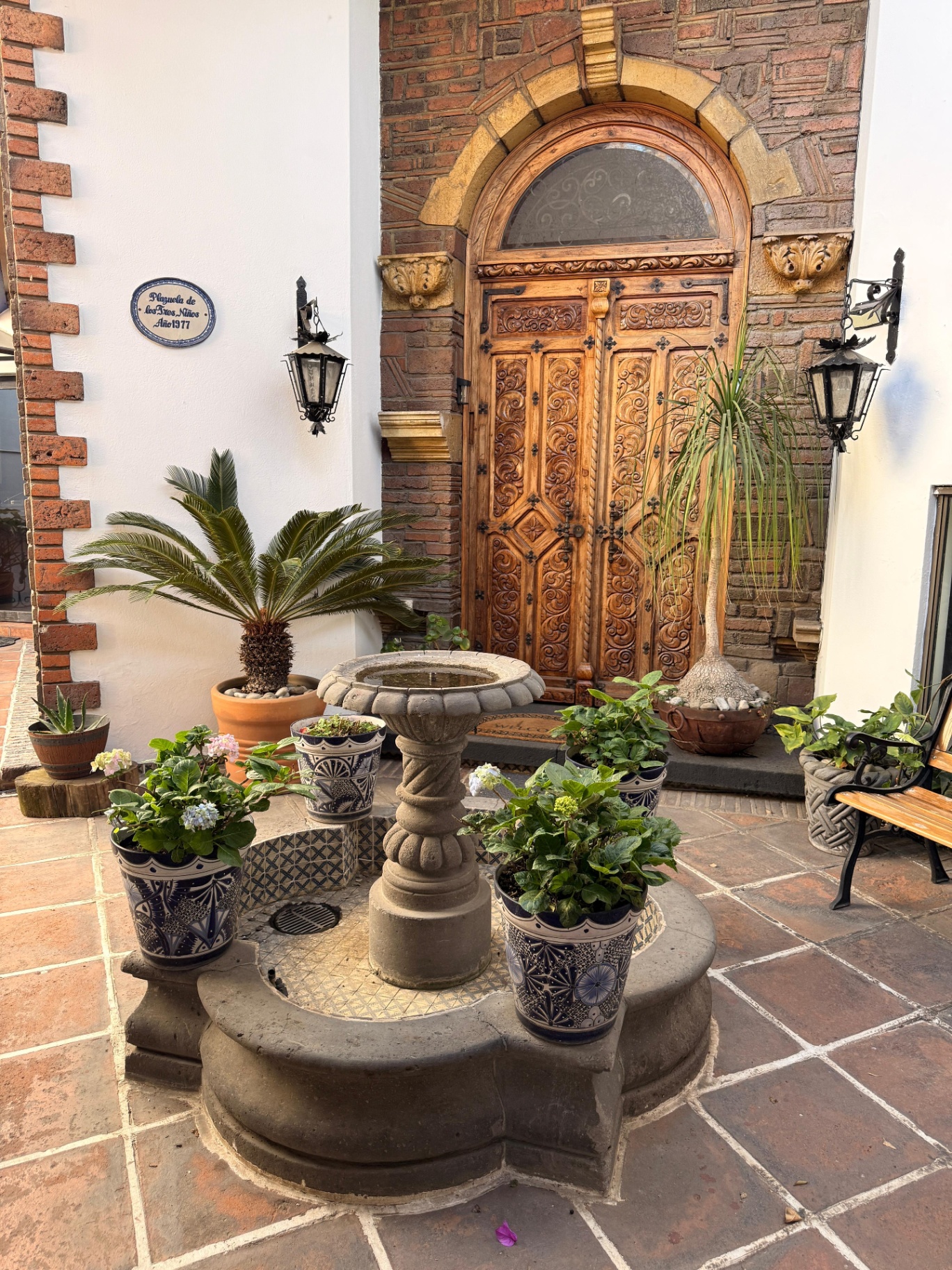 Puerta principal labrada en madera centenaria con cantera labrada